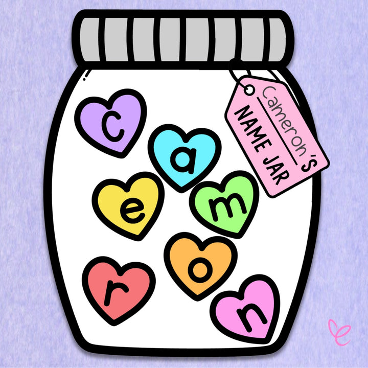 A close-up of a Name Jar craft featuring pastel heart-shaped letters spelling "Cameron" and a pink name tag attached to the jar.