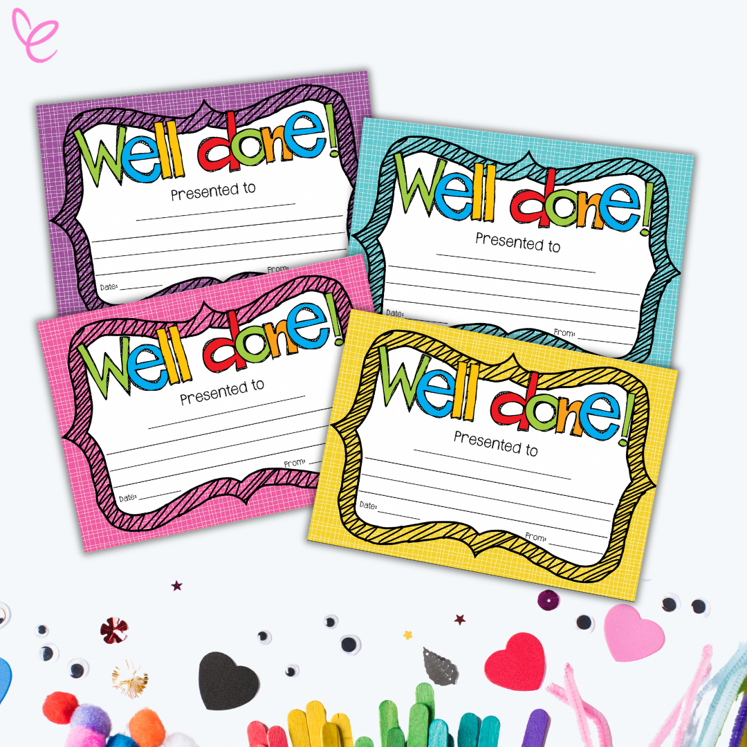 Four vibrant 'Well Done' certificates in purple, blue, pink, and yellow backgrounds, arranged on a craft-themed table with scattered art supplies like googly eyes, hearts, and popsicle sticks.