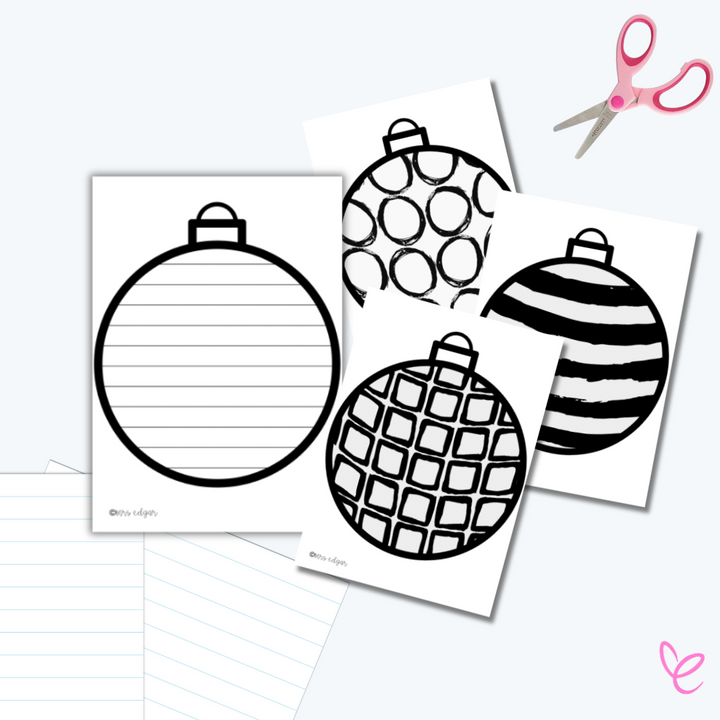 Four Christmas Bauble Craft cards with different designs on a desk with scissors, for students to paint, colour, and decorate.