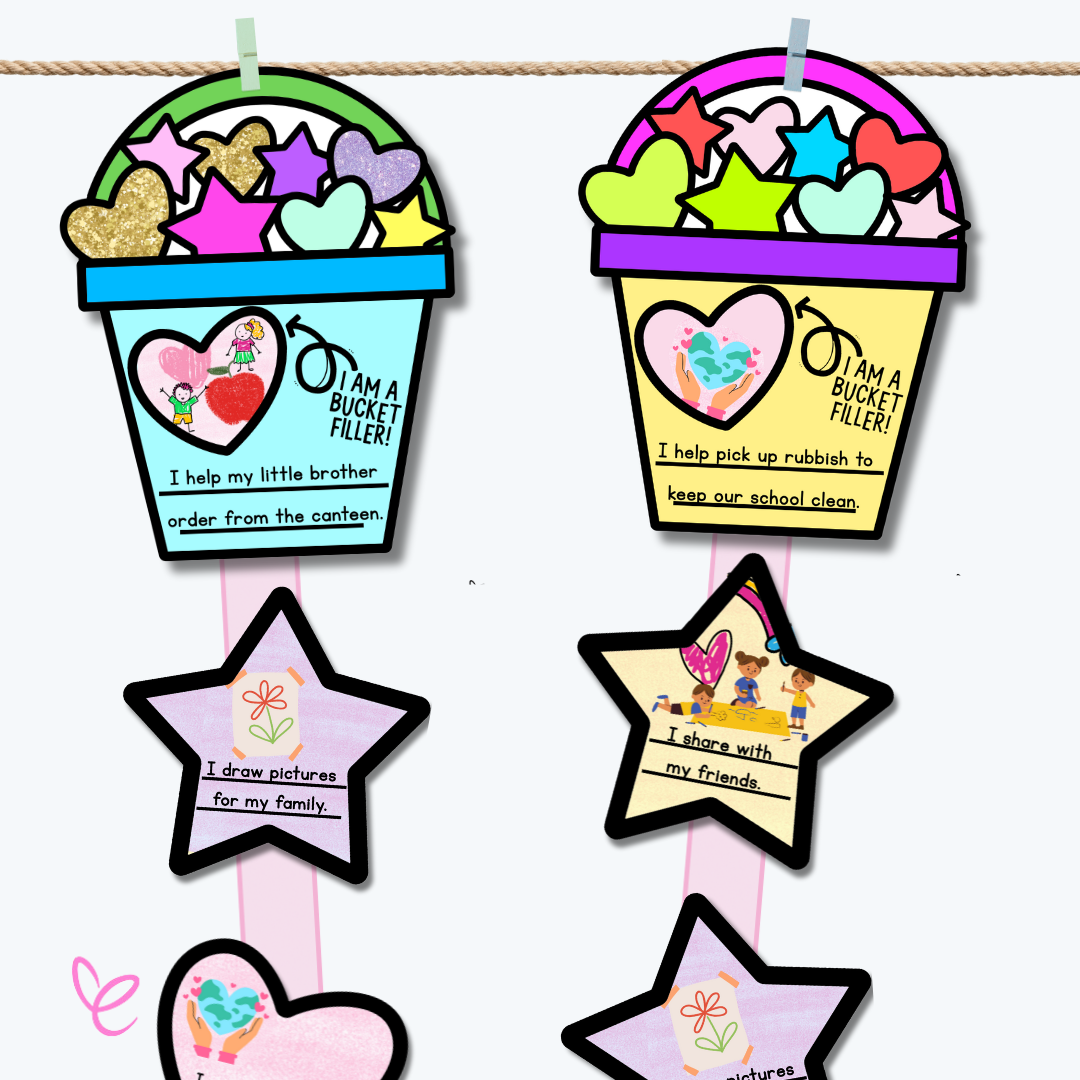 A detailed close-up of a blue 'Bucket Filler' craft displaying a heart with two illustrated children. The text reads, 'I help my little brother order from the canteen.' Glittery hearts and stars decorate the bucket, with kindness-themed messages on attached stars.