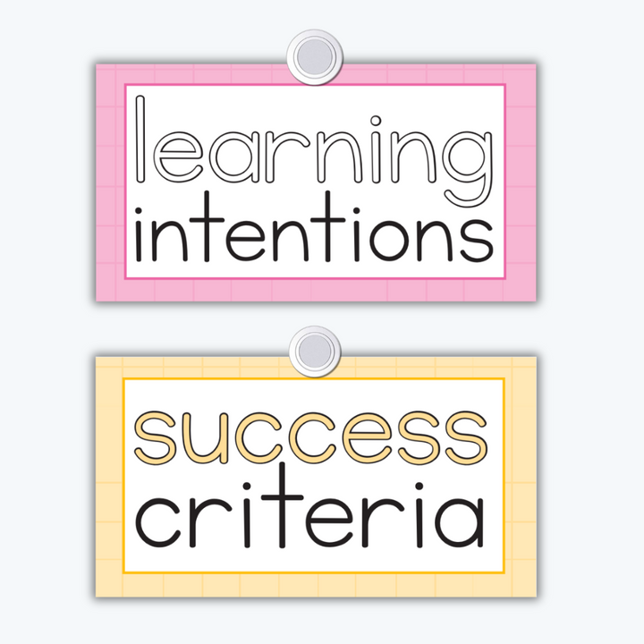 Two classroom signs with pastel backgrounds: 'Learning Intentions' in pink and 'Success Criteria' in yellow. Both signs are bordered and feature a simple, clean font.