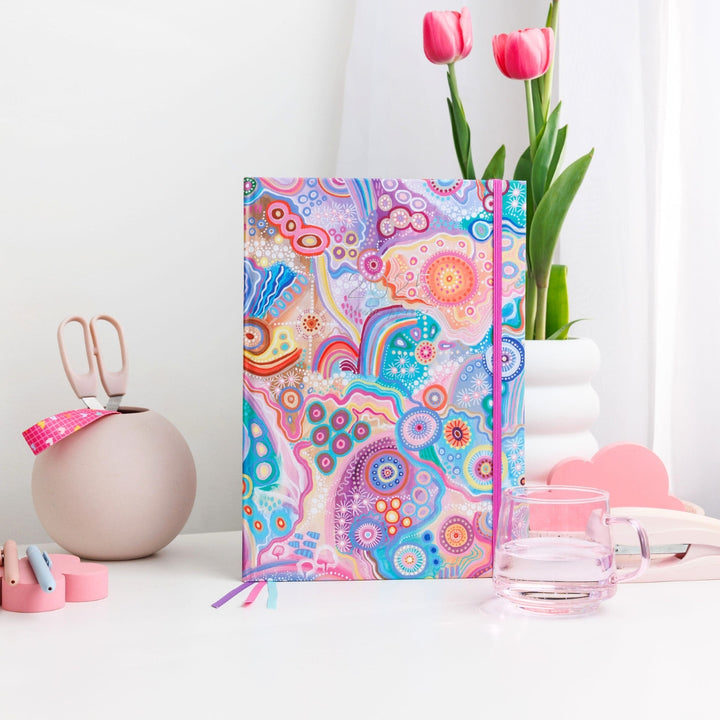 Vibrant 2025 Classic Weekly Teacher Planner styled on a desk with flowers, pens, and stationery items, perfect for organising lesson plans.