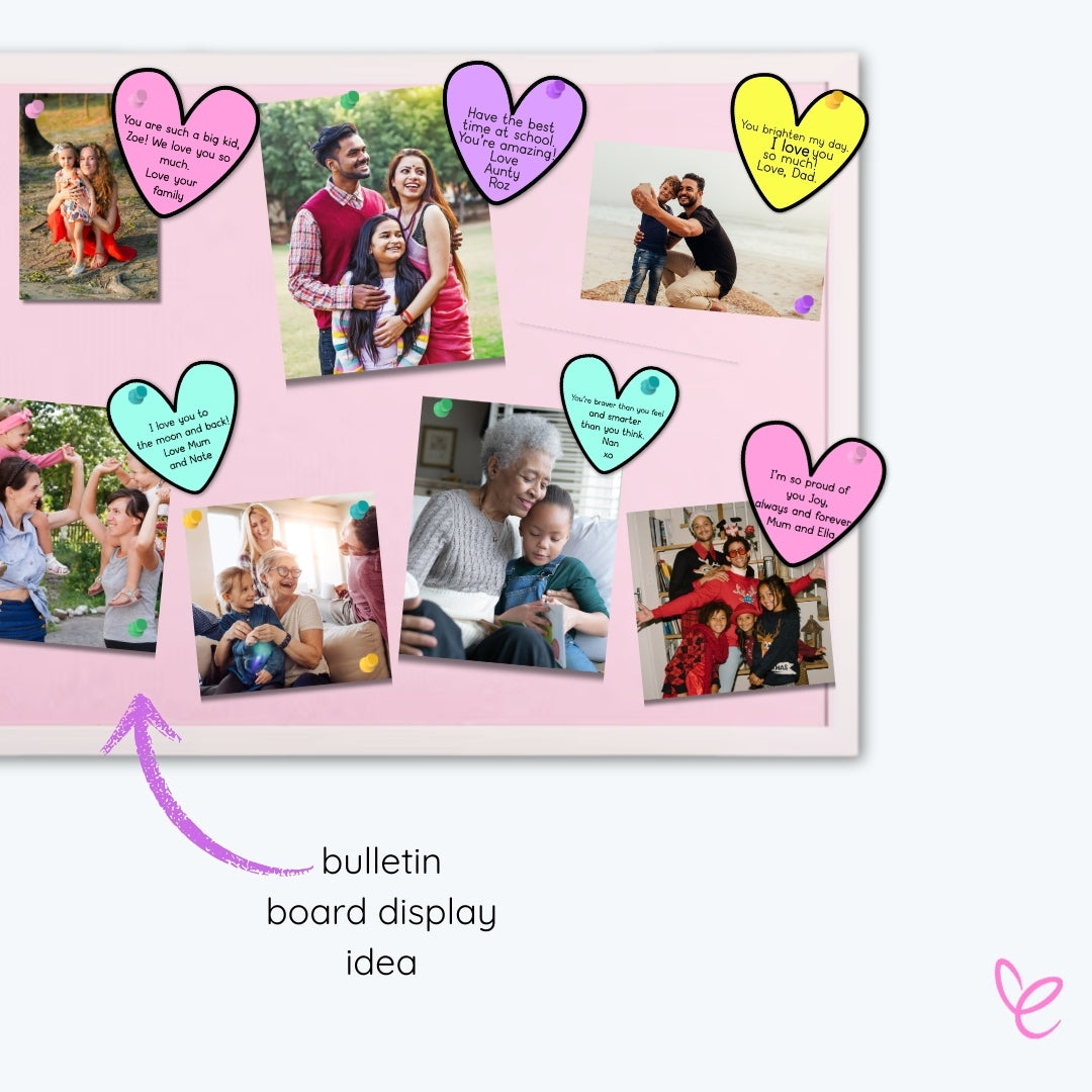 A bulletin board decorated with student family photos and handwritten heart-shaped notes from loved ones, sharing encouragement and support for children.