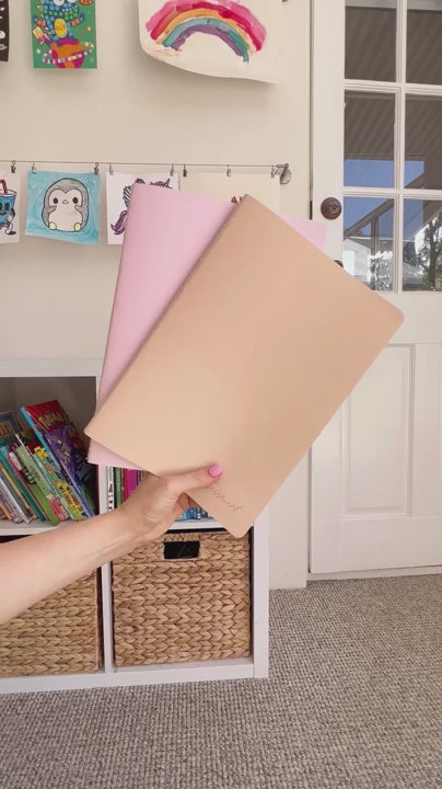 Woman showcasing the internals and external design of the Assessment Journal in Blush and tan Neutrals, highlighting its features and layout.