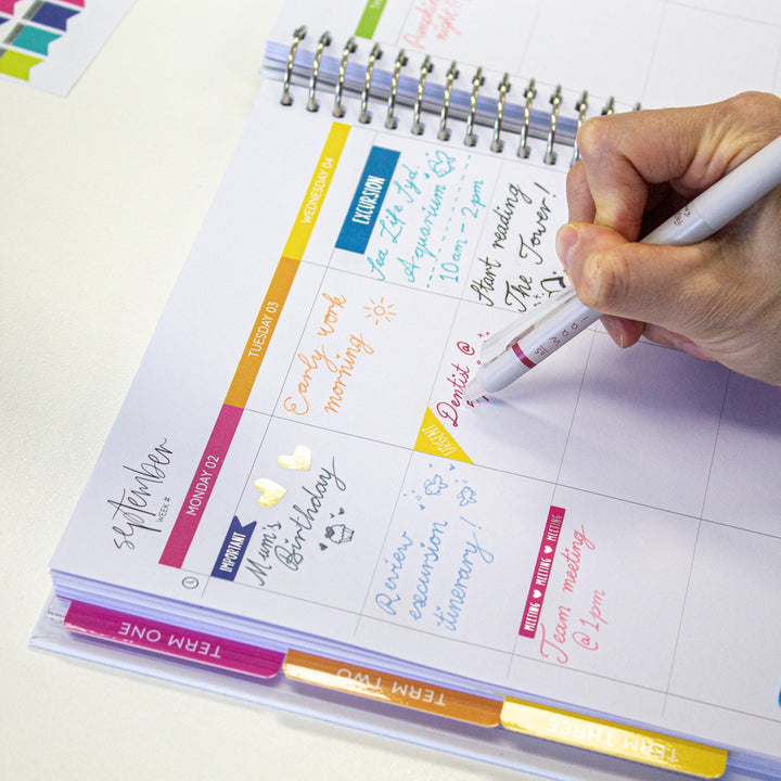 Person demonstrating the erasable tip of a red Waai ballpoint pen, showing its erasable ink feature for easy corrections.